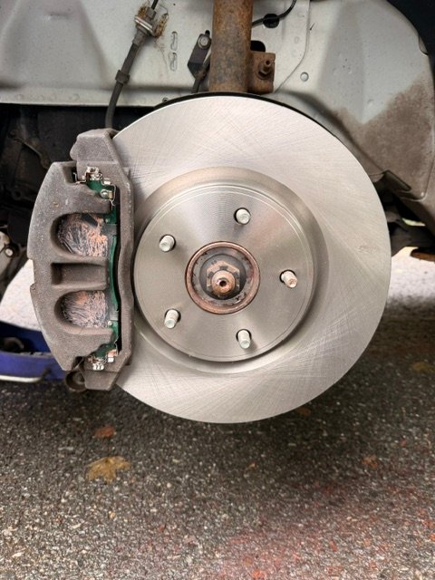 Fresh brake rotor installed on hub, clean surface